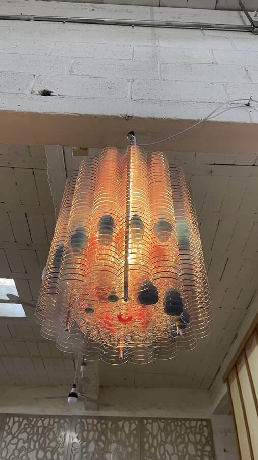 Suspended work installed at height in a live lobby.